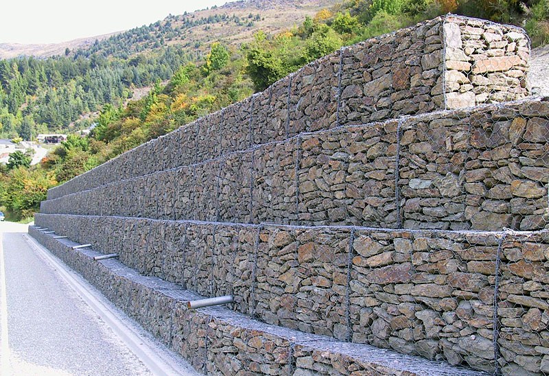 Terraced gabion retaining wall along a highway embankment